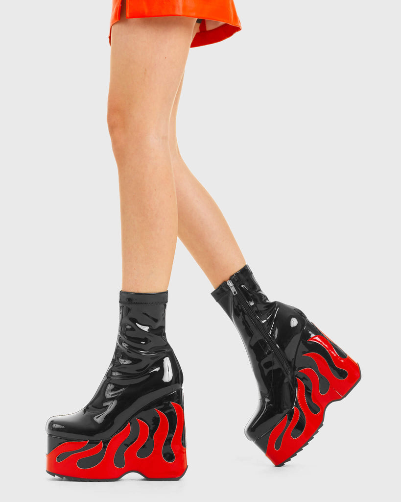 DIRECTED DISSARAY Chaos Calls Chunky Platform Ankle Boots in Black and Red Patent. These platform boots features big red flame with a platformed wedge. Made with eco-friendly materials and 100% cruelty-free, these platform boots are as ethical as they are chic. - Platform Height - Ankle length - Red Flame - Rounded toe - High Heel - 100% vegan SKU: LMF 3540 - BlackPAT/RedPAT