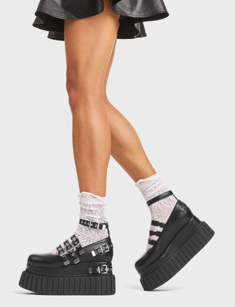 Daydreaming Chunky Platform Creeper Shoes in Black Faux Leather. These creepers feature silver buckles and four adjustable straps, with two decorative straps on the body of the shoe. Made with eco-friendly materials and 100% cruelty-free, these creepers are as ethical as they are edgy! 