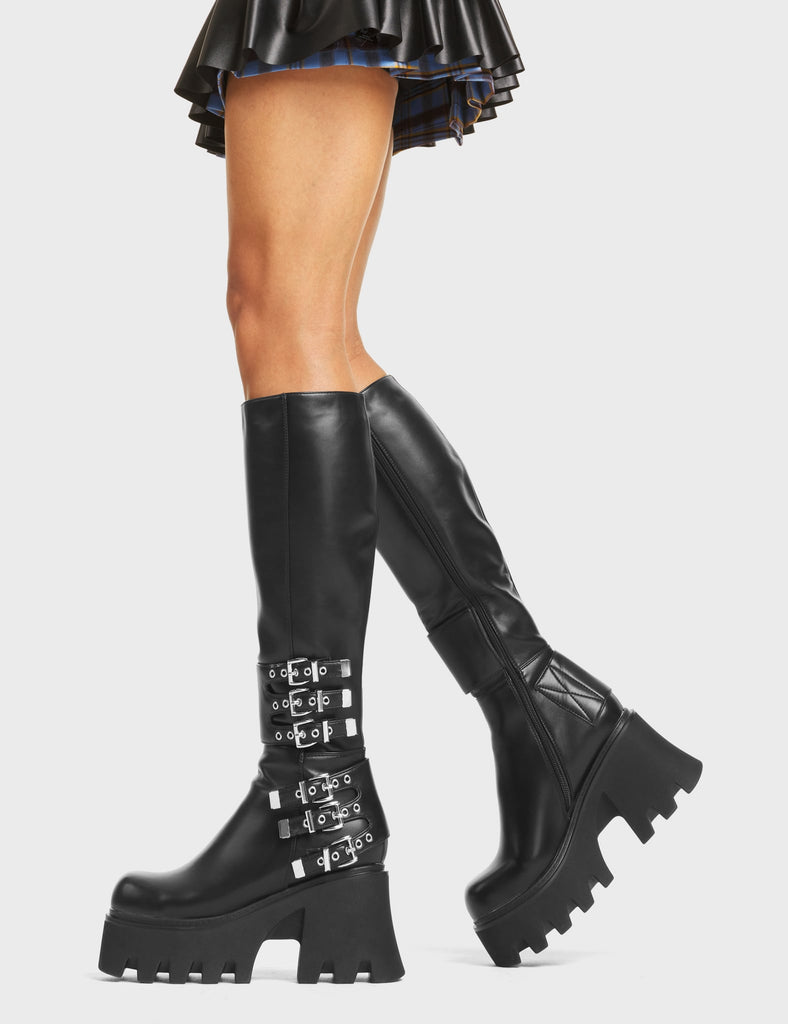 My Prince Chunky Platform Knee High Boots in Black faux leather. These boots feature six adjustable straps with silver eyelets and square-shaped buckles. Made with eco-friendly materials and 100% cruelty-free!