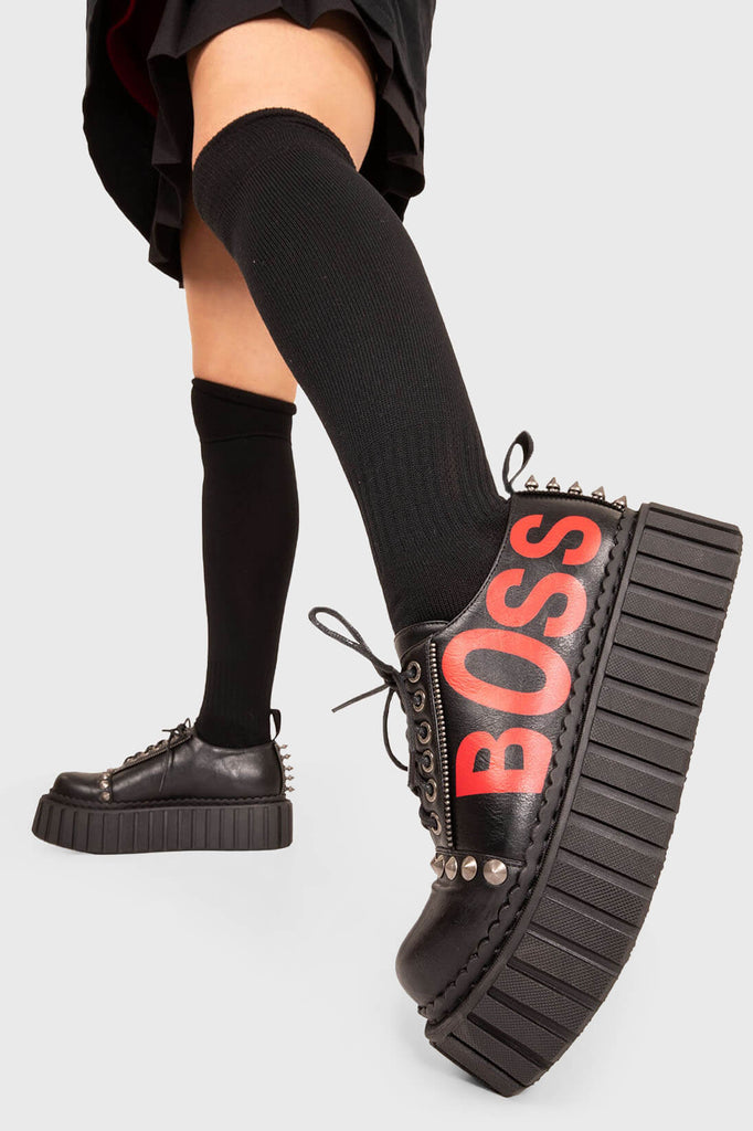 Kicking Sass.
 
 Boss Babe Chunky Creeper shoe in Black faux leather. These vegan creeper shoes feature a "BOSS" red lettering on the side on our chunky sole to highten your attitude. Made with eco-friendly materials and 100% cruelty-free, these Chunky Creeper shoes are as ethical as they are bossy!
 
 - Platform Height: 2.3 inch
 - Black Laces
 - Silver eyelets
 - "BOSS" red lettering
 - Silver spikes 
 - Chunky creeper sole
 - Round toe
 - 100% vegan
 
 SKU: LMF 1592 - Black/Red