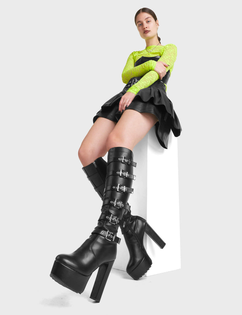 Direct Platform Knee High Boots in Black. Featuring adjustable straps with Silver buckles running up the leg.