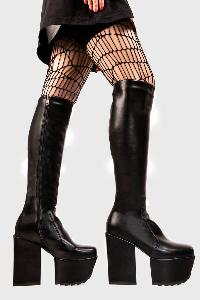 Lift Off 
 
 
 Disappearance Platform Knee High Boots in black faux leather. These black vegan Platform Boots feature on our chunky platform sole,take off with confidence andd ignite your style! Made with eco-friendly materials and 100% cruelty-free, these platform boots are as ethical as they are Bootiful!
 
 
 - Platform Height: 2 inch
 - Heel Height: 4.8 inch
 - Black zipper
 - Chunky platform sole
 - Shark's teeth grip 
 - Round Toe
 - 100% vegan 
 
 SKU: LMF 1981 - BlackPU