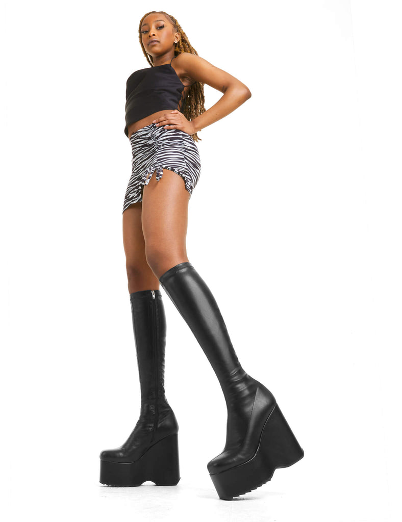 BOOTS TO DIE FOR
 
 Falling Sky Chunky Platform Knee High Boots in Black fitted faux leather. These platform boots feature a minimalist look with a platformed wedge. Made with eco-friendly materials and 100% cruelty-free, these platform boots are as ethical as they are chic.
 
 - Platform Height
 - Knee high length
 - Fitted feel
 - Rounded toe
 - High Heel
 - 100% vegan 
 
 SKU: LMF 3542 - BlackStretchPU