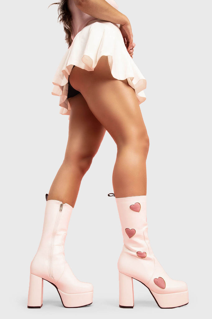 LOVE AT FIRST SIGHT
 
 Game Of Love Platform Wide Calf Boots in White faux leather. These Pink vegan Boots feature our ICONIC Pink faux suede hearts and Platform sole and heel, perfect for adding height and style to any outfit. Made with eco-friendly materials and 100% cruelty-free, these boots are as ethical as they are cute!
 
 
 - Platform Height: 1.25 inch
 - Heel Height: 4.2 inch
 - Wide fit 
 - Calf High length
 - Pink Hearts
 - Whote zipper 
 - Platform sole
 - Round Toe
 - 100% vegan