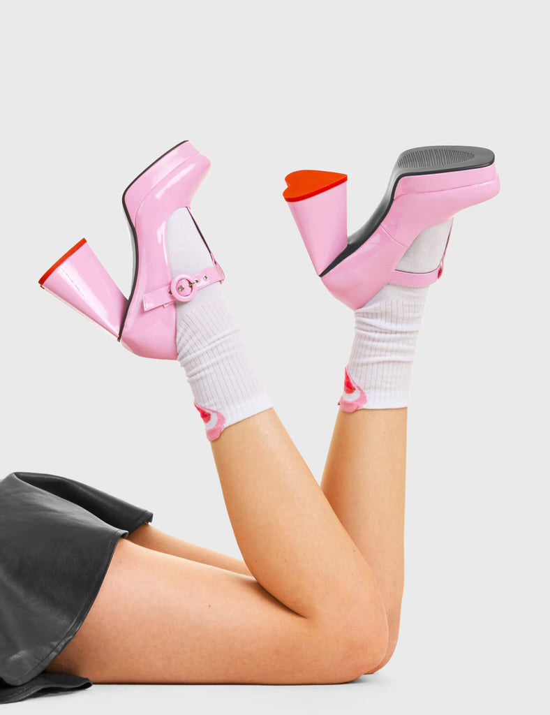 Honeymoon Period Platform Heels in Pink. Features include a heart shaped heel.