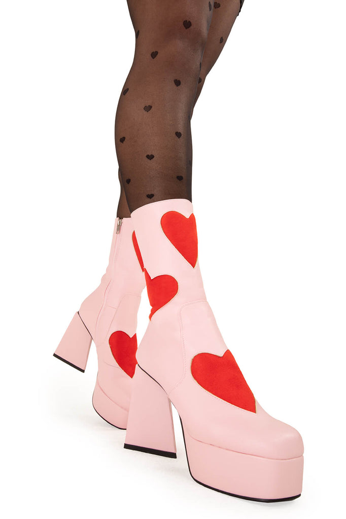 LOVEY DOVEY 
 
 Letter To My Lover Platform Ankle Boots in Pink faux leather. These platform boots feature a pink boot with big red heart all over. Made with eco-friendly materials and 100% cruelty-free, these platform boots are as ethical as they are chic.
 
 - Platform Height
 - Big red hearts
 - Calf length
 - Triangle heel
 - High Heel
 - 100% vegan 
 
 SKU: LMF 3337 - PinkPU/RedHeart