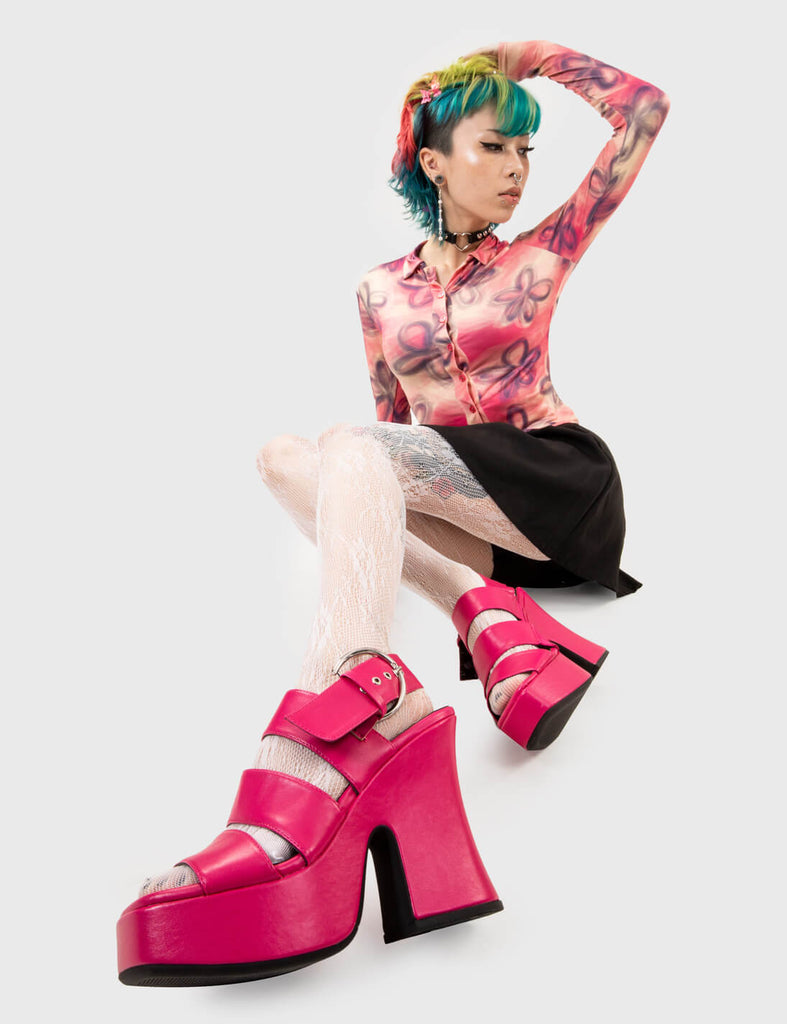 Sun Kissed Steps
 
 Mentally Wired Platform Sandals in Fuchsia. These platform sandals feature three straps across the upper with a adjustable strap across the heel, taste the sweetness of summer with stylish sandals. Made with eco-friendly materials and 100% cruelty-free, these platform boots are as ethical as they are HOT!
 
 - Platform Height
 - Heel Height
 - Adjustable strap
 - Silver eyelets with D shaped buckle
 - Chunky Platform sole
 - Round Toe 
 - 100% vegan 
 
 SKU: LMF 2503 - FuchsiaPU