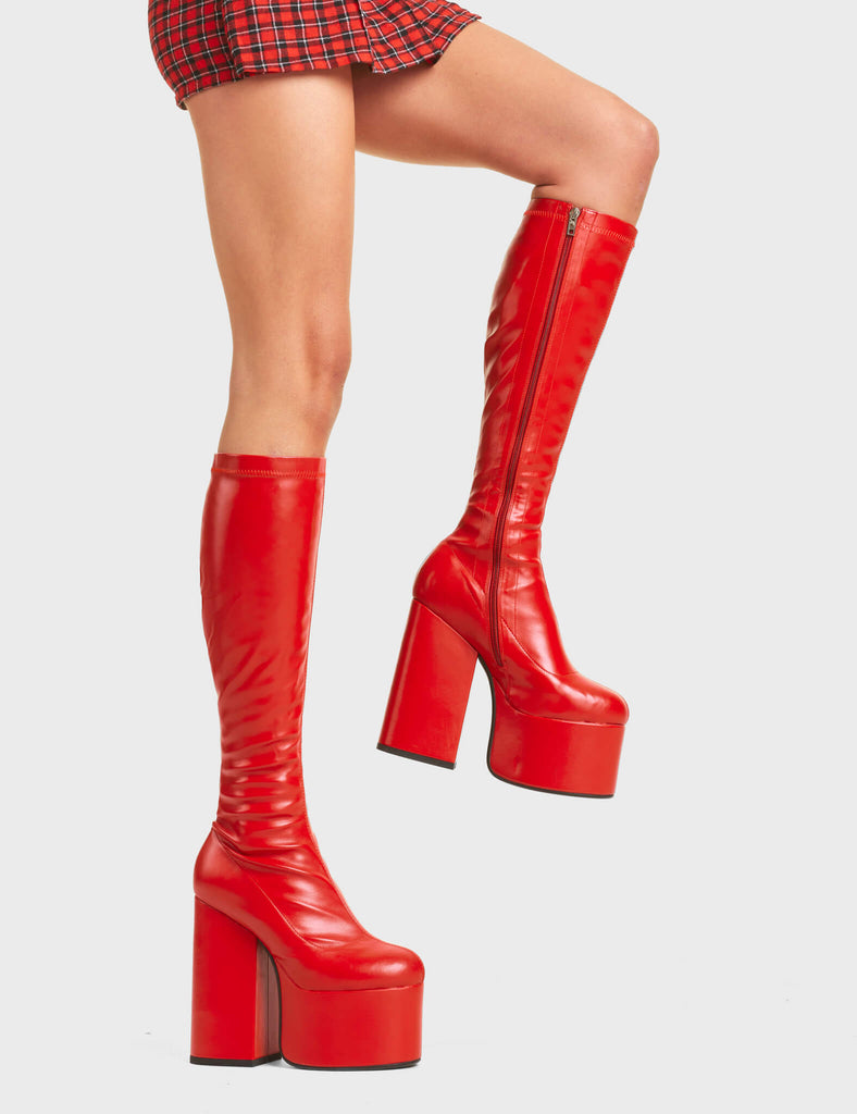 Messenger Platform Knee High Boots in Red faux leather. Feature a minimalist design, platform sole and a stretch fit.