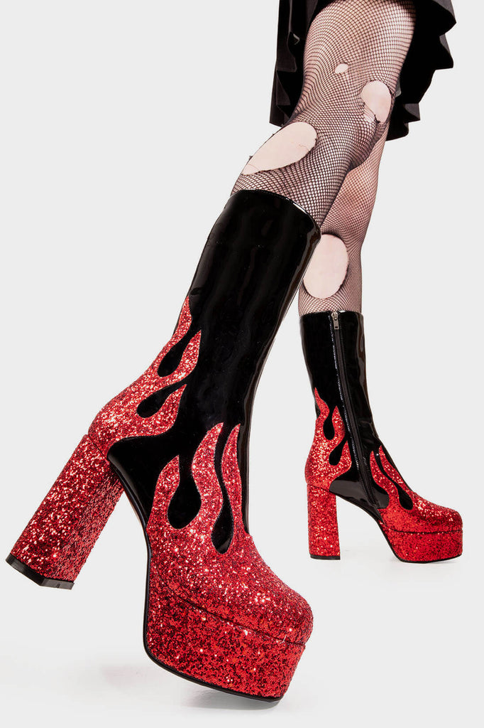 Flame Fury
 
 Miami Platform Calf Boots Boot in Patent Black faux leather. These black vegan Platform Boots feature red glitter flame detail up the sole, flames of style to ingnite your presencel! Made with eco-friendly materials and 100% cruelty-free, these platform boots are as ethical as they are HOT!
 
 
 - Platform Height: 2.6 inch
 - Heel Height: 5.5 inch
 - Black zip
 - Platform Sole 
 - Round Toe
 - 100% vegan 
 
 SKU: LMF 2039 - BlackPAT/RedGlitter