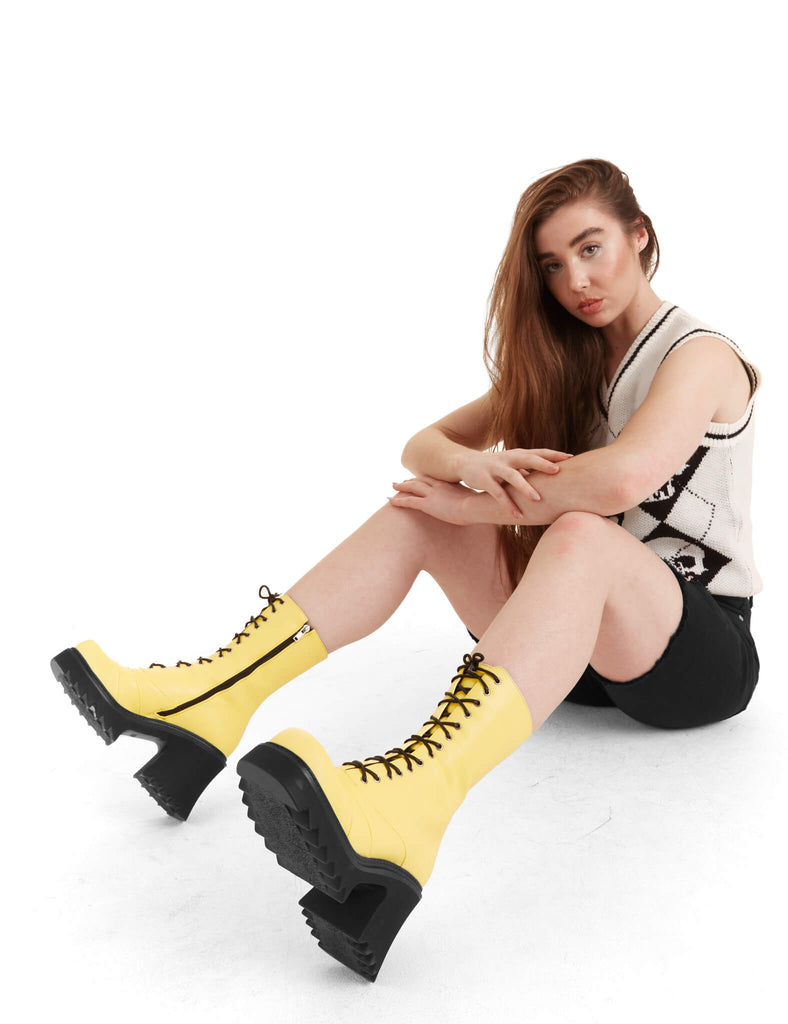LACED UP
 
 On A Buzz Chunky Platform Ankle Boots in yellow faux leather. These vegan western Boots feature black laces and a shark teeth grip sole, very chic. Made with eco-friendly materials and 100% cruelty-free, these boots are as ethical as they are edgy!
 
  
 - Chunky Platform
 - Calf length
 - Shark teeth grip
 - Black laces
 - Rounded toe 
 - 100% vegan 
 
 SKU: LMF 3730 - LemonPU