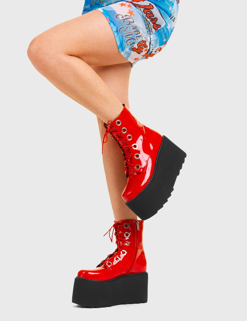 ELEVATED 
 
 Renegade Chunky Platform Ankle Boots in Red patent. These vegan western Boots feature silver eyelets and a shark teeth grip sole, very edgy. Made with eco-friendly materials and 100% cruelty-free, these boots are as ethical as they are Chic!
 
  
 - Chunky Platform
 - Ankle length
 - Shark teeth grip
 - Red Laces
 - Rounded toe 
 - 100% vegan 
 
 SKU: LMF 3746 - RedPAT