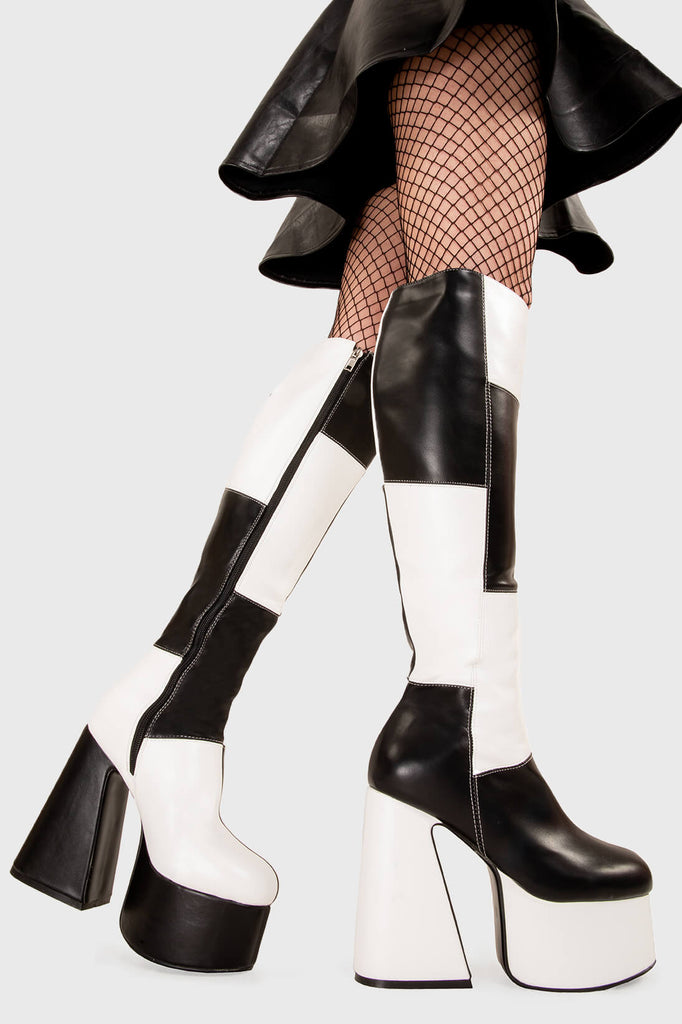 TIME TO DANCE
 
 Runway Platform Knee High Boots in Black and white faux leather. These platform boots feature a black and white patch work design with a triangle heel, keeping it nice and classy. Made with eco-friendly materials and 100% cruelty-free, these platform boots are as ethical as they are chic.
 
 - Platform Height
 - Knee high length
 - Patch work design
 - Triangle heel
 - High Heel
 - 100% vegan 
 
 SKU: LMF 3361 - BlackPU/WhitePU