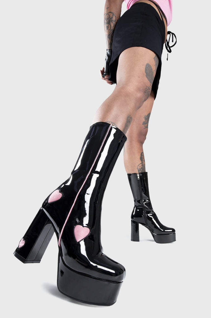 LOVE AT FIRST SIGHT
 
 Secret Lovers Platform Calf Boots in Black Patent. These Black vegan Boots feature our ICONIC Pink faux suede hearts and Platform sole and heel, perfect for adding height and style to any outfit. Made with eco-friendly materials and 100% cruelty-free, these boots are as ethical as they are cute!
 
 
 - Platform Height: 1.25 inch
 - Heel Height: 4.2 inch
 - Calf High length
 - Red Hearts
 - Black zipper 
 - Platform sole
 - Round Toe
 - 100% vegan 
 
 SKU: LMF 1218 - BlackPAT/Pink