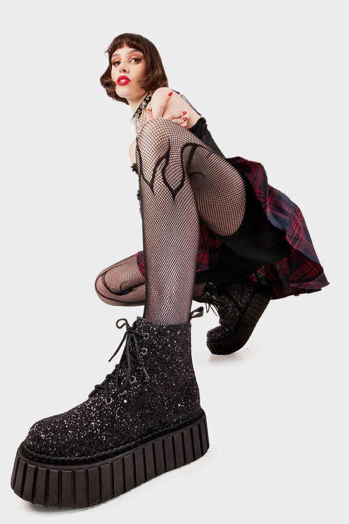 Twinkle Toes
  
 Shooting Star Chunky Ankle Creeper Boot in Black Glitter. These black vegan Platform Boots feature our iconic glitter detail througout with adjustable lace up detail, sparkle with every step! Made with eco-friendly materials and 100% cruelty-free, these platform boots are as ethical as they are glowing!
 
 
 - Platform Height
 - Black zipper 
 - Black laces and silver eyelets 
 - Chunky Creeper sole
 - Round Toe
 - 100% vegan 
 
 SKU: LMF 2007 - BlackGlitter