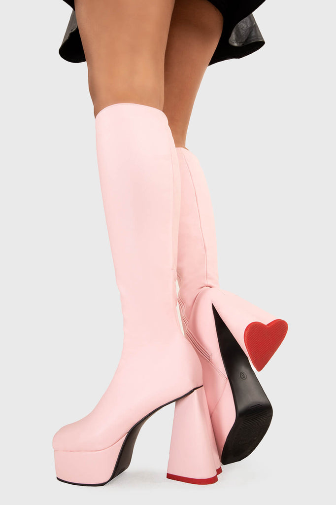 LOVEABLE 
 
 Sweet Talker Platform Knee High Boots in Pink faux leather. These platform boots feature a minimalist look with a heart shaped heel, keeping it nice and classy. Made with eco-friendly materials and 100% cruelty-free, these platform boots are as ethical as they are chic.
 
 - Platform Height
 - Knee length
 - Heart shaped heel
 - Red sole
 - Pink zip
 - High Heel
 - 100% vegan 
 
 SKU: LMF 3313 - PinkPU