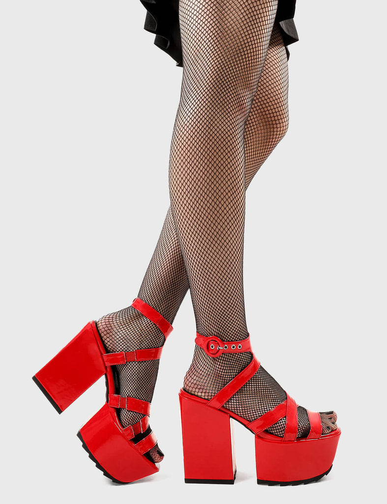 Cutie Pies
 
 Tinted Windows Platform Sandals in Red Patent faux leather. These platform sandals feature red straps across the upper and an adjustable ankle strap with silver eyelets, adding cuteness to every step. Made with eco-friendly materials and 100% cruelty-free.
 
 - Platform Height
 - Heel Height
 - Adjustable red strap
 - Shark's teeth grip
 - Silver eyelets with 'O' shaped buckle
 - Chunky Platform sole
 - Square Toe 
 - 100% vegan 
 
 SKU: LMF 2524 - RedPAT