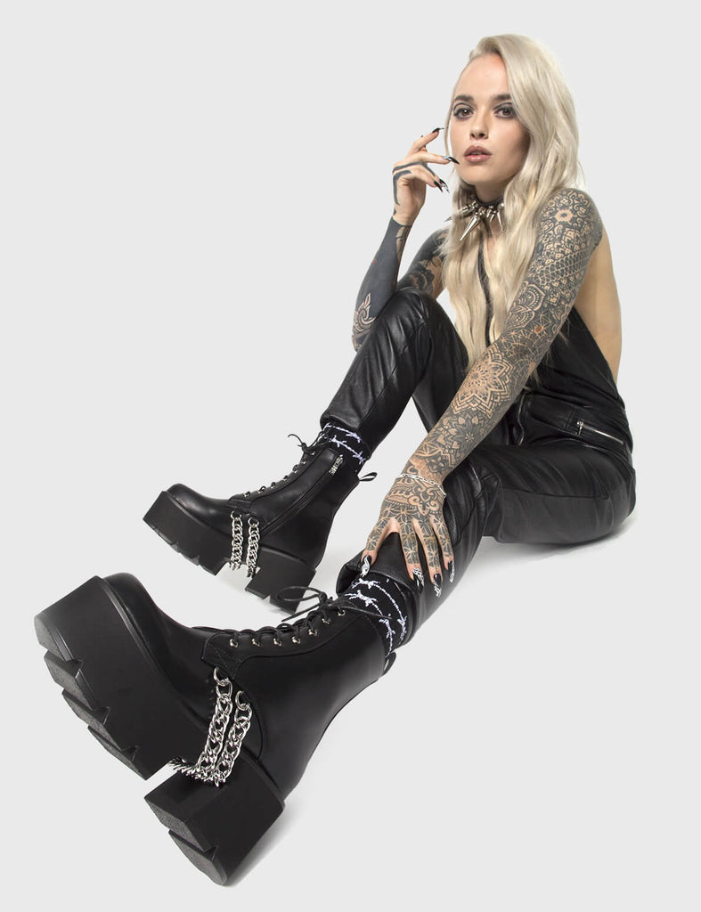 COMFY DRIP'
 
 Trapped Chunky Platform Ankle Boots in Black faux leather. These vegan Platform Ankle Boots feature hanging silver chains and our CHUNKY Platform sole, making them the perfect comfy Boots with a little extra! Made with eco-friendly materials and 100% cruelty-free, these boots are as ethical as they are special!
 
 
 - Platform Height: 3 inch
 - Mid ankle length 
 - Black zipper
 - Lace up
 - Black pull tab
 - Cunky Platform sole
 - Round toe 
 - 100% vegan 
 
 SKU: LMF 0173 - BlackPU