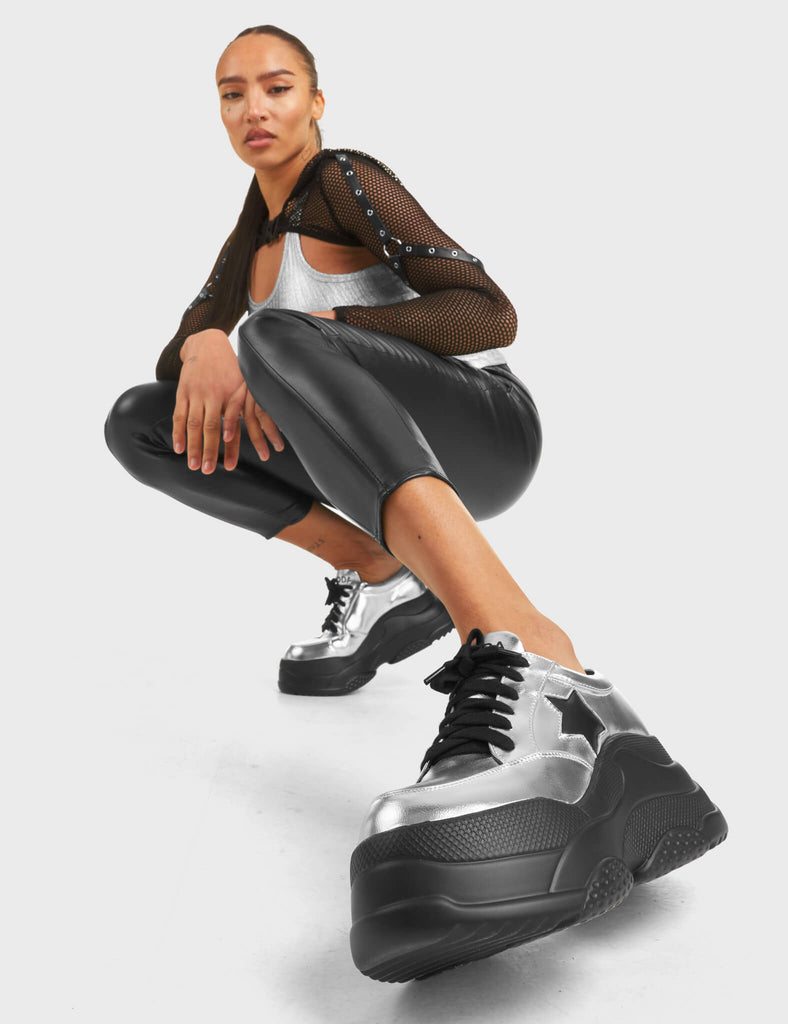 Venus Chunky Platform Sneakers in Silver. Feature black lace-up fastening and a black star.