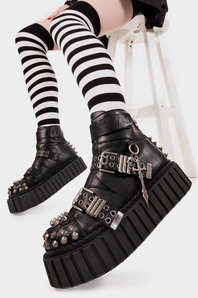 Sleek and Spiked 
 
 Virtual Insanity Chunky Ankle Creeper Boot in Black faux leather. These black vegan Boots feature two adjustable straps with silver eyelets and square shaped buckles as well as silver spiked studs on the upper, front and back of the boots.
 
 
 - Platform Height
 - Black zipper 
 - Silver spiked studs
 - Two adjustable straps
 - Silver eyelets and sqaure shapeed buckles
 - Silver hanging cross and skull 
 - Chunky Creeper sole
 - Round Toe
 - 100% vegan 
 
 SKU :LMF 2013 - Black/Spike