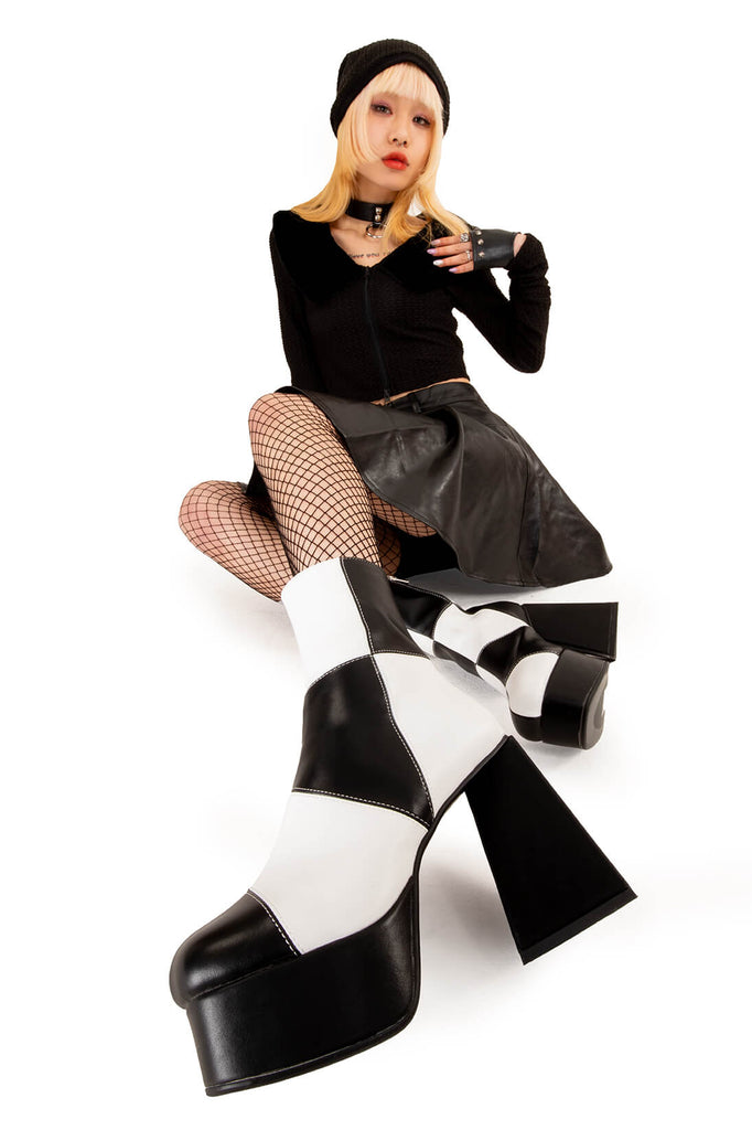 TIME TO DANCE
 
 Wait A Minute Platform Ankle Boots in Black and white faux leather. These platform boots feature a black and white patch work design with a triangle heel, keeping it nice and classy. Made with eco-friendly materials and 100% cruelty-free, these platform boots are as ethical as they are chic.
 
 - Platform Height
 - Ankle length
 - Patch work design
 - Triangle heel
 - High Heel
 - 100% vegan 
 
 SKU: LMF 3330 - BlackPU/WhitePU
