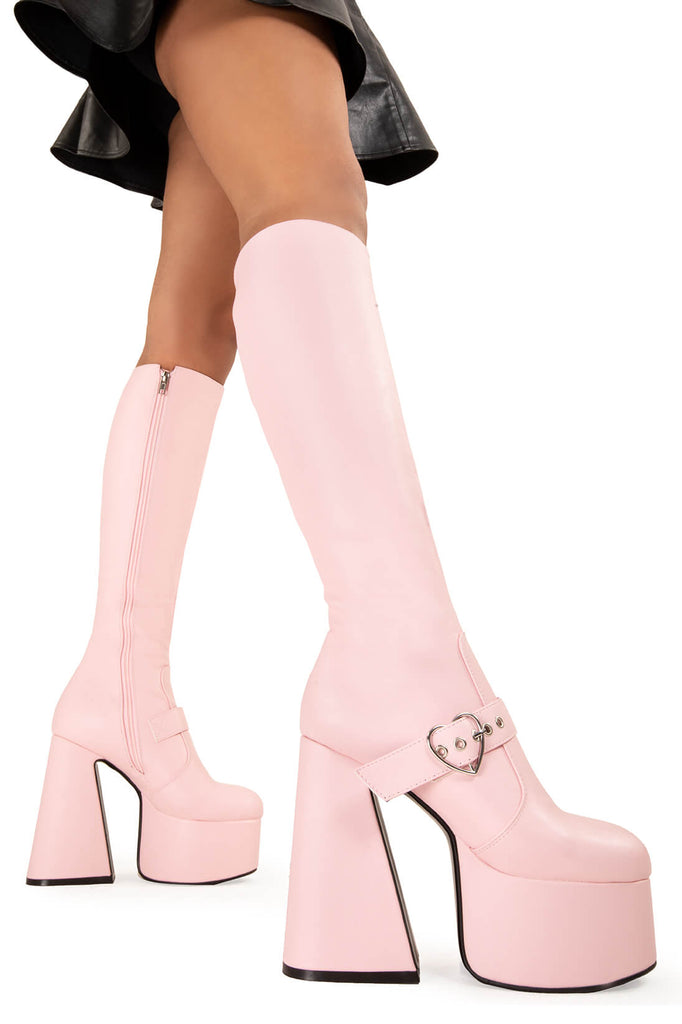 YOU STOLE MY HEART
 
 Walk With Love Platform Knee High Boots in Pink faux leather. These platform boots feature a minimalist look with a Flared heel, and an adjustable strap. Made with eco-friendly materials and 100% cruelty-free, these platform boots are as ethical as they are chic.
 
 - Platform Height
 - Knee high 
 - Silver heart buckle
 - Flared heel
 - High Heel
 - 100% vegan 
 
 SKU: LMF 3358 - PinkPU